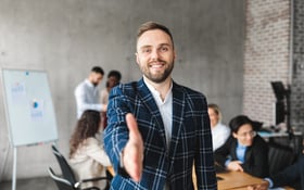 Successful Young Entrepreneur Stretching Hand For Handshake Standing In Office